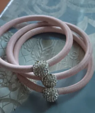 Pulsera de bisutería rosa con adornos plateados