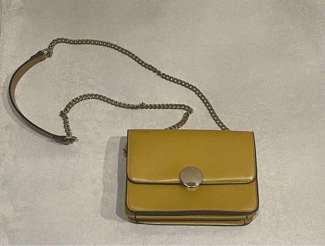Bolso de mano amarillo con cadena dorada