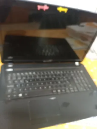 Ordenador portátil negro funciona con el cargador