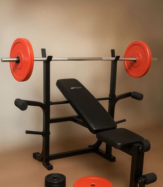 Banco de pesas con barra olímpica y discos