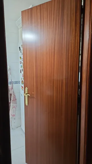 Puerta de madera con manilla dorada