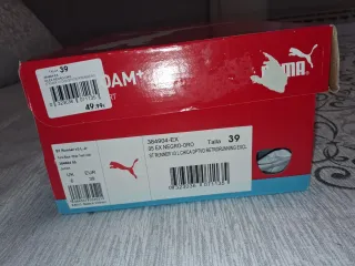 Deportivos Puma Negros y Dorados." Con caja