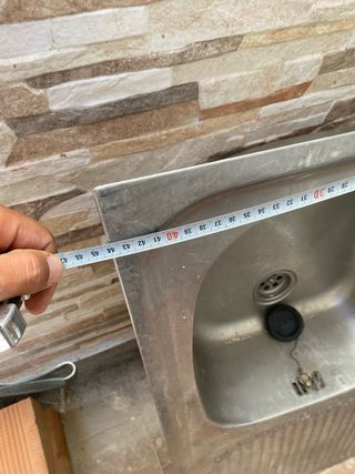 Fregadero de metal plateado con grifo