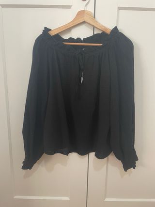 Blusa negra escote volante