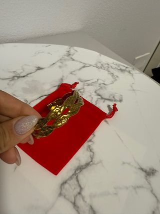 Bracciale rigido dorato intrecciato