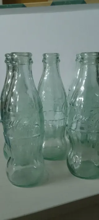 Bottiglie antiche verdi di Coca-Cola