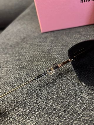 Gafas de sol Miu Miu negras y doradas