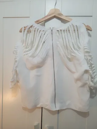 Blusa blanca con diseño de flecos