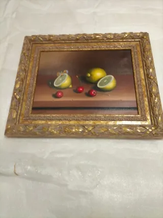 Cuadro naturaleza muerta con limones y cerezas.