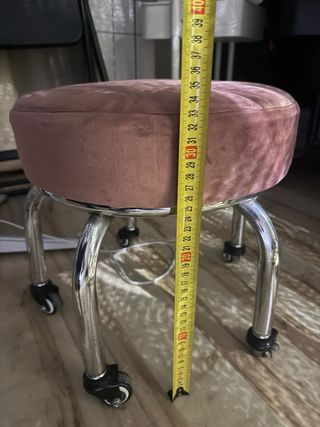 Taburete rosa con ruedas para pedicura
