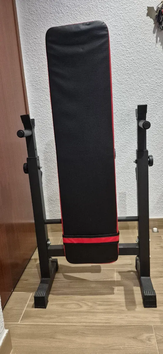 Banco de pesas plegable, mancuernas y barra z.