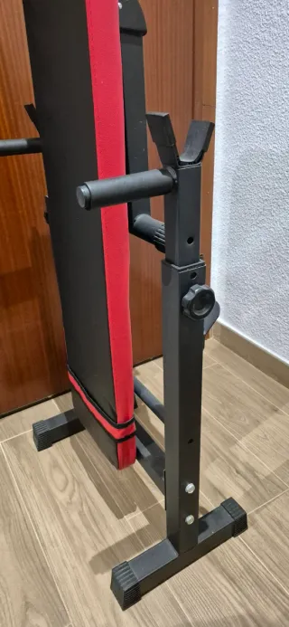 Banco de pesas plegable, mancuernas y barra z.