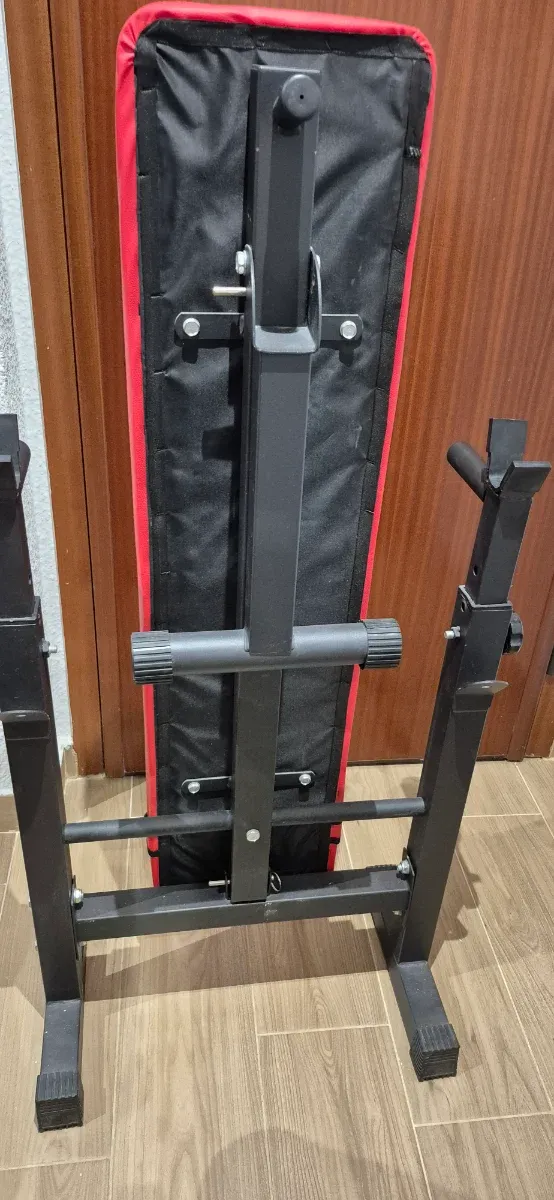 Banco de pesas plegable, mancuernas y barra z.