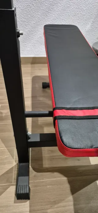 Banco de pesas plegable, mancuernas y barra z.