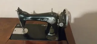 Máquina de coser Singer en uso. Con mueble