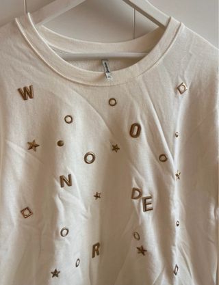 Sudadera blanca con letras doradas