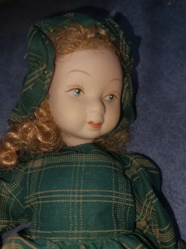 Muñeca de porcelana con vestido de cuadros