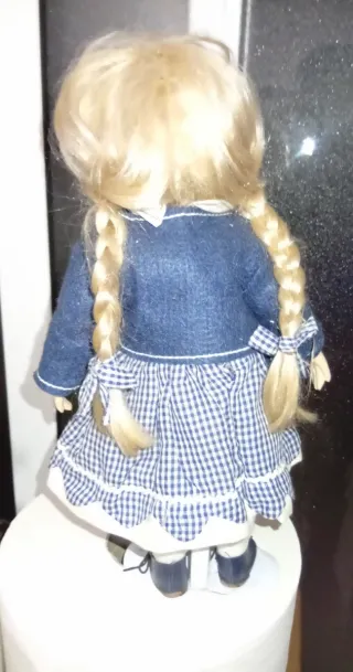Muñeca de porcelana con vestido de cuadros