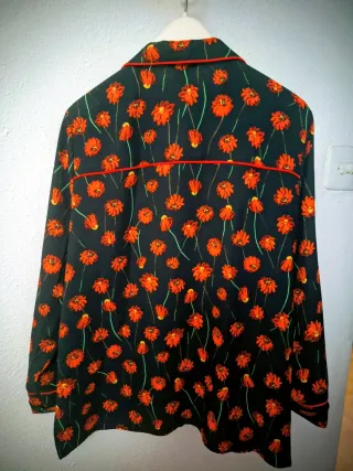 Traje de pantalón negro y rojo de flores.