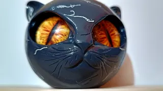 Testa gatto resina occhi gialli