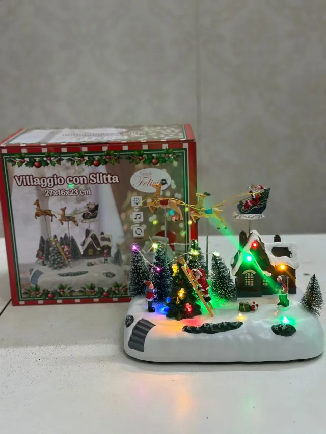 Villaggio con Slitta Luci e Musica 27x16x23 cm