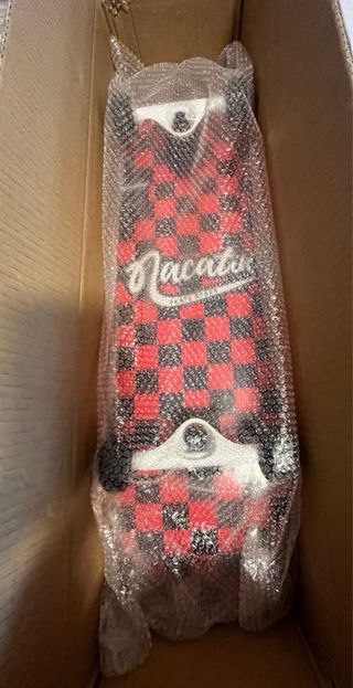 Monopatín rojo a cuadros, Nuevo de fábrica