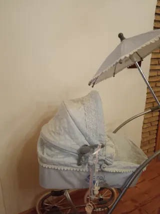 Carro de muñecas azul con capota y sombrilla