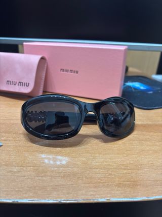 Occhiali Miu Miu neri e oro