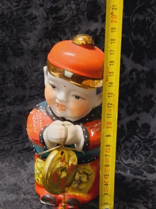 Coppia figure orientali con monete