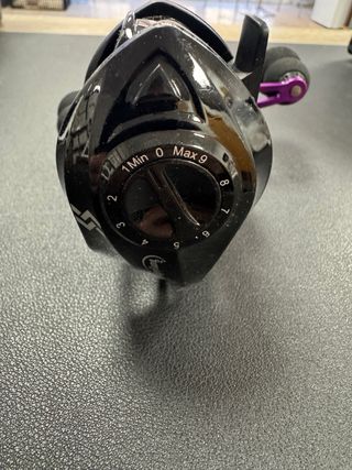 Carrete de pesca negro y morado