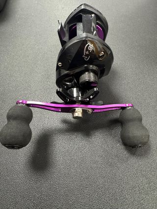 Carrete de pesca negro y morado