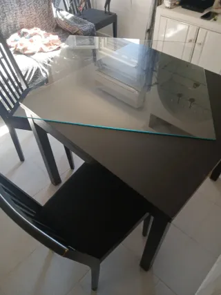 Mesa de cristal con 4 sillas negras