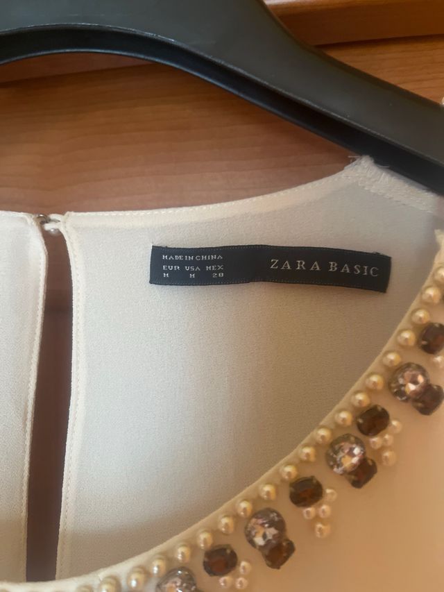 Blusa panna con decorazioni