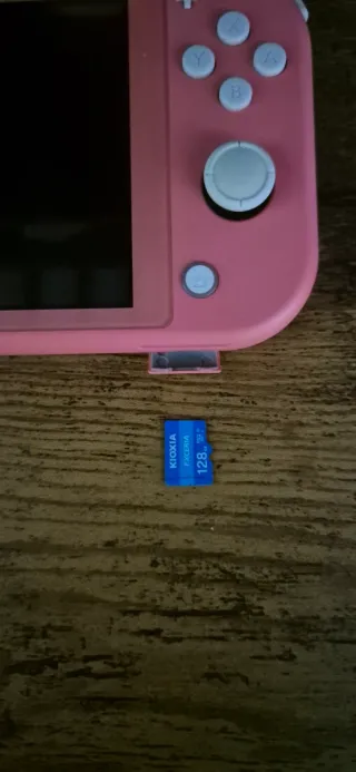 Nintendo Switch Lite Coral + Funda y Caja + Juego