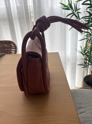 Bolso de mano rosa con nudo
