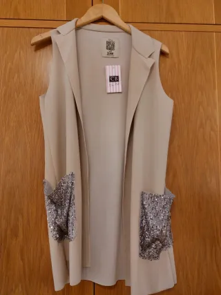 Chaleco beige con bolsillos plateados