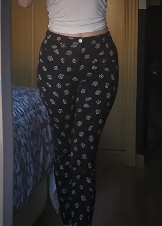 Pantalones negros con estampado de margaritas