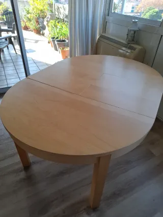 Mesa redonda extensible de madera.
