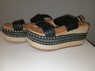 Cuñas negras y de yute con tachuelas