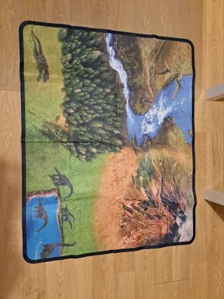 Caja de dinosaurios de juguete. Incluye tapete