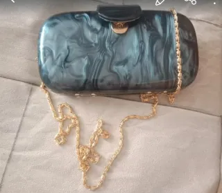 bolso de mano tipo clutch rígido