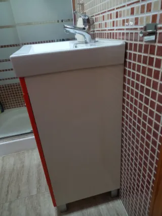 Mueble de baño naranja con lavabo