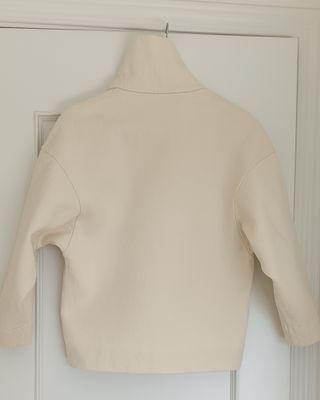 Jersey COS cuello alto algodón oversize marfil