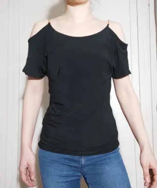 Camiseta negra cadena dorada hombros descubiertos