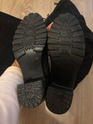 Botas altas negras por encima de la rodilla