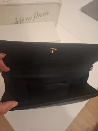 Bolso de mano negro con cadena dorada