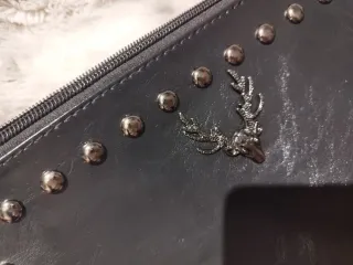 Cartera de mano negra con tachuelas