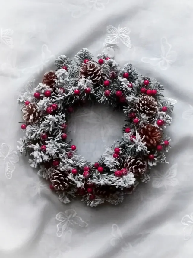 Ghirlanda luminosa con pigne e bacche