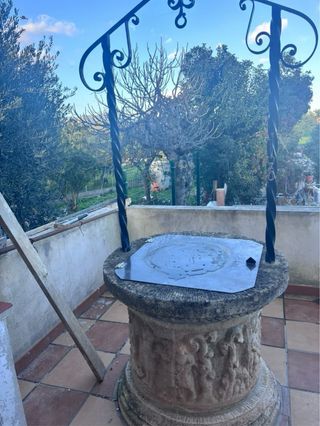 Pozo decorativo de piedra y forja