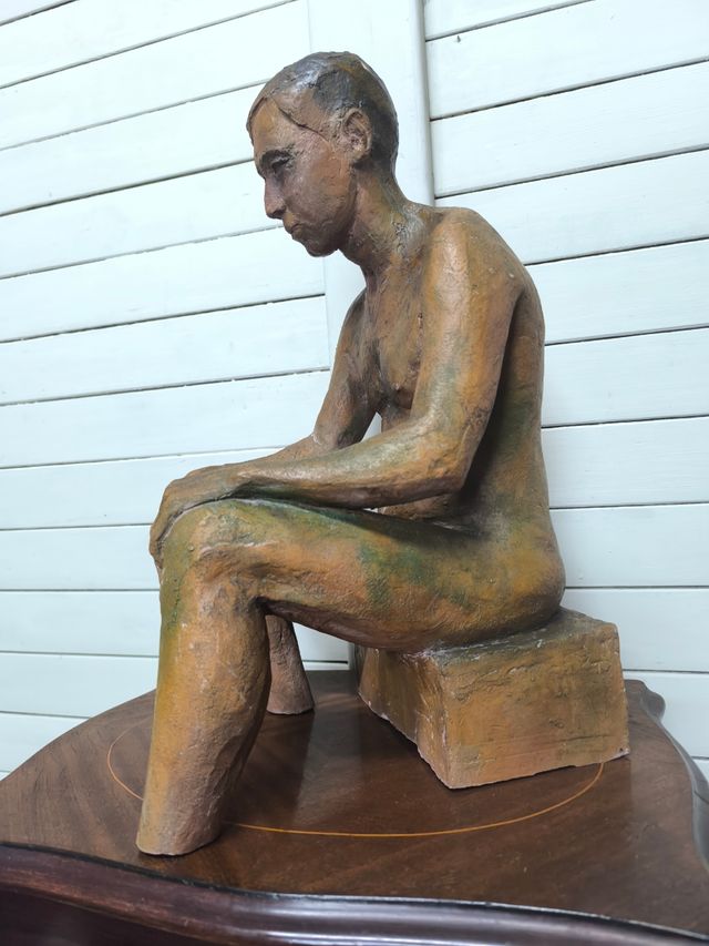 Escultura de hombre firmada.